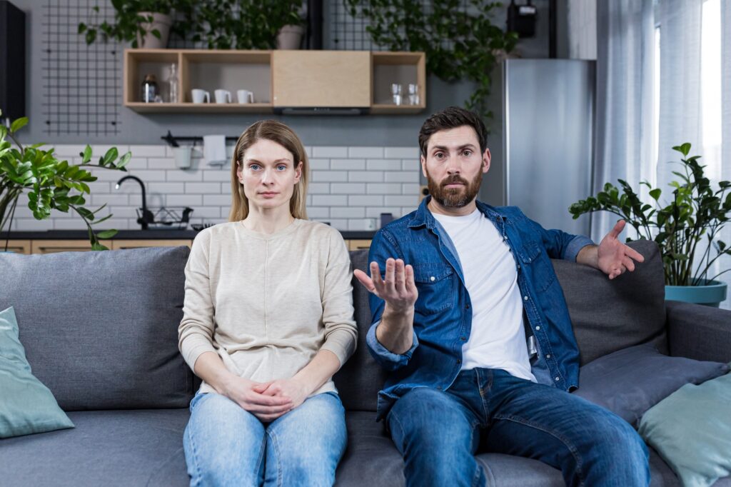 Family conflict. Young couple, family, man and woman on a reception at the psychologist.