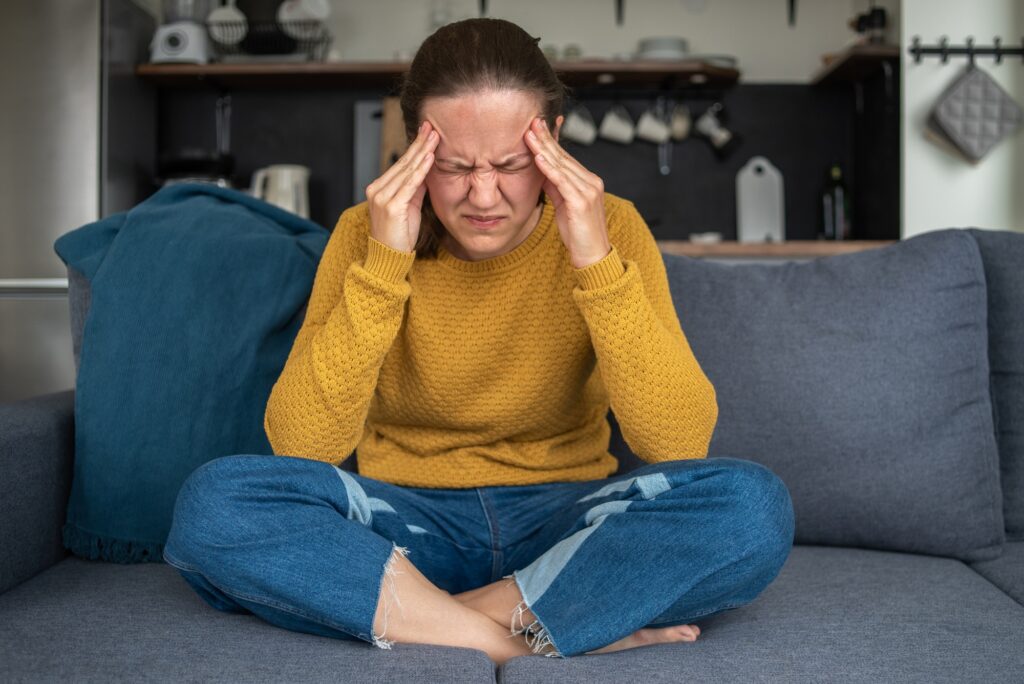 Woman with headache holding head